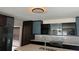 Modern kitchen features sleek dark cabinets, stainless steel appliances, and stylish backsplash, creating a contemporary look at 7727 Glynde Hill Dr, Orlando, FL 32835
