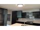 Modern kitchen features sleek dark cabinets, stainless steel appliances, and stylish backsplash, creating a contemporary look at 7727 Glynde Hill Dr, Orlando, FL 32835