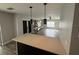 Bright and open living space with views of the kitchen island, modern lighting, and neutral color palette at 7727 Glynde Hill Dr, Orlando, FL 32835