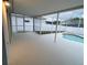 A covered and screened-in patio overlooks a backyard pool and green lawn at 7727 Glynde Hill Dr, Orlando, FL 32835