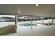 The covered, screened-in patio looks out to the backyard with pool and green grass at 7727 Glynde Hill Dr, Orlando, FL 32835