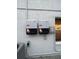 Solar inverters mounted on the side of the home near an AC unit at 7727 Glynde Hill Dr, Orlando, FL 32835
