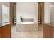 Luxurious bathroom featuring a tiled platform tub, matching storage baskets, and natural light at 8047 Chilton Dr, Orlando, FL 32836