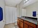 Bathroom featuring a granite vanity, ceramic tile flooring and shower/tub combo at 8047 Chilton Dr, Orlando, FL 32836