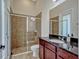 Bathroom featuring tiled glass shower with stone floor and granite vanity with raised basin sink at 8047 Chilton Dr, Orlando, FL 32836