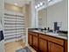 Bathroom featuring a double vanity with granite countertop, shower/tub combo and light-colored wooden flooring at 8047 Chilton Dr, Orlando, FL 32836