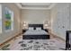 Spacious bedroom showcasing a tray ceiling, a plush rug, and matching nightstands with mirrors at 8047 Chilton Dr, Orlando, FL 32836