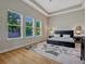 Bright bedroom with a tray ceiling, large windows, and a decorative area rug at 8047 Chilton Dr, Orlando, FL 32836