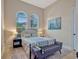 This bedroom has two arched windows, a plush rug, and a comfortable-looking upholstered bed frame at 8047 Chilton Dr, Orlando, FL 32836