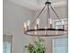 Stylish dining room with a vintage-inspired chandelier and natural light streaming through the window at 8047 Chilton Dr, Orlando, FL 32836