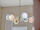 Modern lighting featuring a decorative pendant chandelier with spherical bulbs in neutral colors at 8047 Chilton Dr, Orlando, FL 32836
