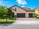 Charming curb appeal with a well-manicured lawn, lush landscaping, brick driveway, and a beautiful home exterior at 8047 Chilton Dr, Orlando, FL 32836