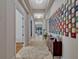 Bright and airy hallway with stylish decor, wood floors, and views into the living room creating a welcoming atmosphere at 8047 Chilton Dr, Orlando, FL 32836
