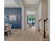 Inviting home hallway with decorative wall paneling, light hardwood floors, and views into the living and dining spaces at 8047 Chilton Dr, Orlando, FL 32836