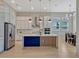 Modern kitchen boasts white cabinets, a large island with marble countertops, and stainless steel appliances at 8047 Chilton Dr, Orlando, FL 32836