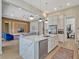Open kitchen with a large island and stainless appliances offers seamless transition to living area at 8047 Chilton Dr, Orlando, FL 32836