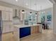 Beautiful kitchen featuring white cabinets, an island with pendant lighting, and open dining space at 8047 Chilton Dr, Orlando, FL 32836