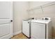 Bright laundry room featuring a washer and dryer, tile floors, and a wire rack for storage at 8047 Chilton Dr, Orlando, FL 32836