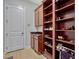 Mud room featuring wooden cabinets, granite countertops and shelves for shoe storage and organization at 8047 Chilton Dr, Orlando, FL 32836