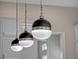 Close up of modern pendant lights highlighting the kitchen's sleek design at 8047 Chilton Dr, Orlando, FL 32836