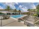 Resort-style pool with fountains, lounge chairs, palm trees and covered seating area for relaxing outdoor enjoyment at 8047 Chilton Dr, Orlando, FL 32836