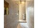 Modern bathroom with a tiled walk-in shower, a built-in niche, and mosaic tile floor at 8047 Chilton Dr, Orlando, FL 32836