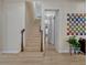 Staircase featuring light wood floors and railings, leading to the upper level of the home with natural light at 8047 Chilton Dr, Orlando, FL 32836