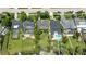 Aerial view showcases waterfront homes with pools, lush landscaping, and serene lakeside setting at 8473 Granada Blvd, Orlando, FL 32836
