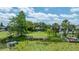 Aerial view showcasing a vast backyard with a pond, dock, and lush greenery creating a serene outdoor oasis at 8473 Granada Blvd, Orlando, FL 32836