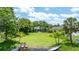 Expansive green backyard with mature trees leading to waterfront access, great for outdoor activities at 8473 Granada Blvd, Orlando, FL 32836