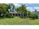 Expansive backyard featuring lush landscaping, a well-maintained lawn, and a patio area ideal for outdoor relaxation at 8473 Granada Blvd, Orlando, FL 32836