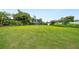 Large grassy backyard offers ample space and privacy, framed by mature trees and manicured landscaping at 8473 Granada Blvd, Orlando, FL 32836