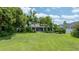 Spacious backyard features lush lawn and mature trees providing a private and serene outdoor space at 8473 Granada Blvd, Orlando, FL 32836