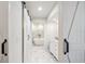 Modern bathroom with marble floors, a free-standing tub, and barn doors at 8473 Granada Blvd, Orlando, FL 32836