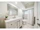 Clean and bright bathroom with a large mirror, modern vanity, and a shower with tub combination at 8473 Granada Blvd, Orlando, FL 32836