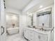 Luxurious bathroom boasts marble floors, double vanities, and a freestanding tub at 8473 Granada Blvd, Orlando, FL 32836