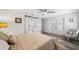 Bedroom features wood floors, a ceiling fan, an ensuite bathroom with barn doors, and a sitting area at 8473 Granada Blvd, Orlando, FL 32836