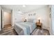 Cozy bedroom with barn door closet, wood flooring, and natural light from the window at 8473 Granada Blvd, Orlando, FL 32836