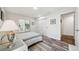Light filled bedroom featuring wood flooring, barn door closet and outside views at 8473 Granada Blvd, Orlando, FL 32836