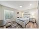 Comfortable bedroom with wood floors, a plush queen bed, and ample natural light from the large window at 8473 Granada Blvd, Orlando, FL 32836