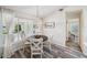 Bright breakfast nook features a modern light fixture, wood floors, and water views at 8473 Granada Blvd, Orlando, FL 32836