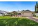 Charming single-story home with well-maintained landscaping and a two-car garage on a sunny day at 8473 Granada Blvd, Orlando, FL 32836