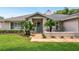 Inviting home featuring a quaint front porch, well-maintained landscaping, and charming curb appeal at 8473 Granada Blvd, Orlando, FL 32836