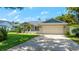Charming single-story home with well-maintained landscaping and a two-car garage on a sunny day at 8473 Granada Blvd, Orlando, FL 32836