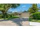 Charming single-story home with well-maintained landscaping and a two-car garage under a blue sky at 8473 Granada Blvd, Orlando, FL 32836