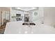 Bright kitchen features white cabinets, stainless steel appliances, a modern faucet, and large quartz countertop at 8473 Granada Blvd, Orlando, FL 32836