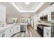 Modern kitchen features white cabinets, stainless steel appliances, and breakfast nook overlooking the water at 8473 Granada Blvd, Orlando, FL 32836