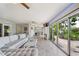 Bright living room with glass sliding doors to the lanai and access to other indoor seating areas at 8473 Granada Blvd, Orlando, FL 32836