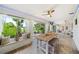 Bright living room with lake view, large windows, ceiling fans, and dining table, perfect for relaxing and enjoying the scenery at 8473 Granada Blvd, Orlando, FL 32836