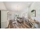 Cozy living room features a decorative brick wall, modern furnishings, and hardwood floors at 8473 Granada Blvd, Orlando, FL 32836